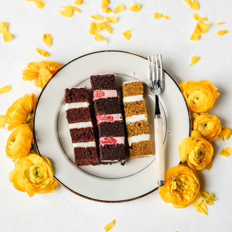 Sliced cake on a plate with yellow flowers around it